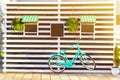 Old blue bicycle near a store or bakery wall with wooden white boards in a rustic style with chalkboard, signboards with sunshades Royalty Free Stock Photo