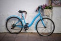 Old blue bicycle resting against a wall Royalty Free Stock Photo