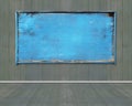 Old blue blank weathered noticeboard on dark green wooden wall