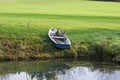 Old blue boat near a pond in a forest during the daytime Royalty Free Stock Photo