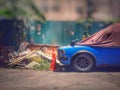 The old blue car is parked with brown cloth in the daytime, Royalty Free Stock Photo