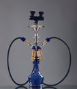 An old blue ceramic hookah on a grey background Royalty Free Stock Photo
