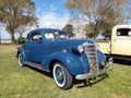 Old blue 1938 Chevrolet Chevy Master business coupe by General Motors on the lawn
