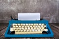 An old blue classic typewriter on wooden desk. Copy space. For text purpose Royalty Free Stock Photo