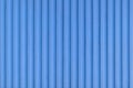 Old blue concrete background wall with vertical line ribbed. Stripes as a texture Royalty Free Stock Photo