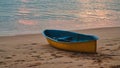 An old blue Dinghy lies on a sandy beach at sunset Royalty Free Stock Photo