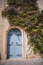 Old blue door with flowers on the facade of a building in Malta Royalty Free Stock Photo