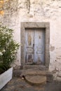 Old blue door in stone wall Royalty Free Stock Photo