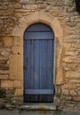 Old blue door in yellow stone wall with padlock Royalty Free Stock Photo