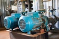 Old blue electric motor with pump, gate valve and pressure gauge on the pipeline. Royalty Free Stock Photo