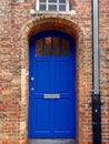 Old blue exterior door in brick wall Royalty Free Stock Photo