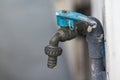 Old blue faucet is on a white wall. Royalty Free Stock Photo