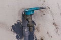 Old blue faucet is on a white wall. Royalty Free Stock Photo