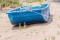 Old blue flat bottom boat on beach Royalty Free Stock Photo