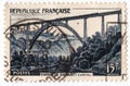 An old blue french postage stamp with an image of Garabit Viaduct railway bridge Royalty Free Stock Photo