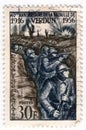 An old blue french postage stamp with an of world war one soldiers in trenches in the battle of verdun