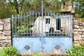 Saint-Ceneri-le-Gerei/FRANCE - April 24, 2018: Old blue gate and typical stone house in a village in Lower Normandy