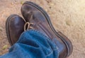 Old blue jeans and brown boots Royalty Free Stock Photo