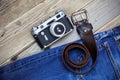 Old blue jeans, vintage leather belt and ancient rangefinder cam Royalty Free Stock Photo