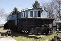 Old blue locomotive standing on the rails on the background of blue sky