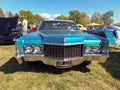 Old blue luxury Cadillac DeVille sedan four door 1970 parked on the grass. Classic car. Copyspace Royalty Free Stock Photo