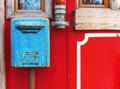 Old blue mailbox hanging on red wall Royalty Free Stock Photo