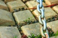 Old blue massive chain on the background of concrete tiles