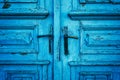 Old blue massive wooden door with two handles