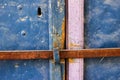 Old blue metal dirt door with keyhole and rusty metal lockas a beautiful vintage background Royalty Free Stock Photo