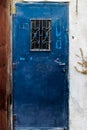Old blue metal dirt door with keyhole and rusty metal lockas a beautiful vintage background Royalty Free Stock Photo