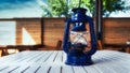 Old blue oil lamp on a wooden table Royalty Free Stock Photo