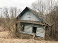 Old blue old dilapidated wooden abandoned ruined blue village house of beams with broken windows Royalty Free Stock Photo