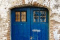 Old blue old wooden door with mailbox in a brick wall Royalty Free Stock Photo