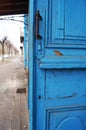 Bright multi-colored fence kindergartenOld blue open door and street view Royalty Free Stock Photo