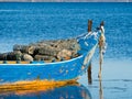 Old blue and orange fisherman boat with fish trap Royalty Free Stock Photo