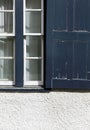 Old Blue Peeling Paint Vintage Window Shutter on White Wall Royalty Free Stock Photo
