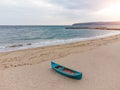 Old blue pink wooden boat on sandy beach Royalty Free Stock Photo