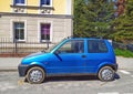 Old blue private small city compact car Fiat Cinquecento parked