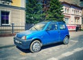 Old blue private small city compact car Fiat Cinquecento parked