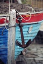 Old blue and red boat with black anchor Royalty Free Stock Photo