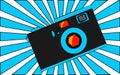 Old blue retro vintage antique hipster obsolete camera with a lens and a diaphragm against a blue triangle ray. Royalty Free Stock Photo