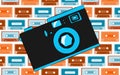 Old blue retro vintage antique hipster obsolete camera with a lens and a diaphragm on the background of a pattern of multi-colored Royalty Free Stock Photo