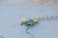 Old Blue Rope Tied to Yellow Cleat on Concrete Pier Royalty Free Stock Photo