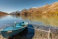 Blue rowboat on a mountain lake in fall Royalty Free Stock Photo