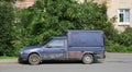 Old blue rusty broken pickup truck in the courtyard of a residential building