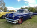 Old blue 1950s Ford Mercury Monterey two door on the lawn