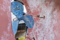 Blue sailboat propeller in a red painted hull Royalty Free Stock Photo