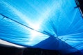 old blue shading net with sun light in outdoor market texture an Royalty Free Stock Photo