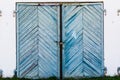 Old, blue, skewed garage doors on a collapsing brick wall Royalty Free Stock Photo