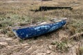 Old Blue Skiff boat on grass. Old wooden dinghy rowboat beached on grass. Royalty Free Stock Photo